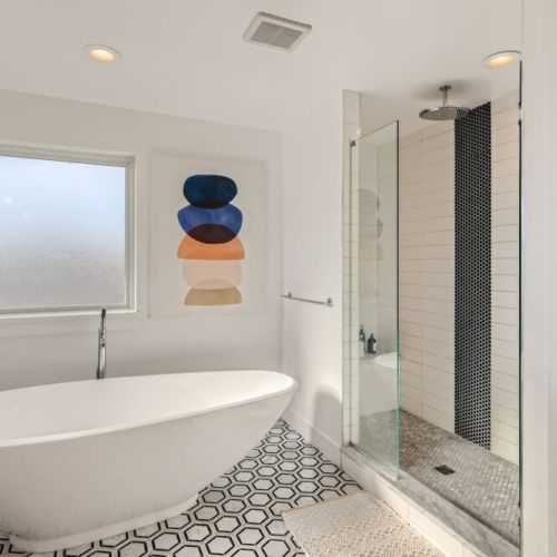 Primary five piece bathroom with walk-in shower and deep soaking tub